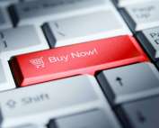 Red 'buy now!' button on a computer keyboard.
