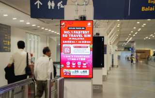 Digital advertisement for travel sim card in airport.