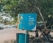 a blue sign sitting on the side of a road