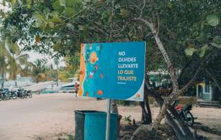 a blue sign sitting on the side of a road